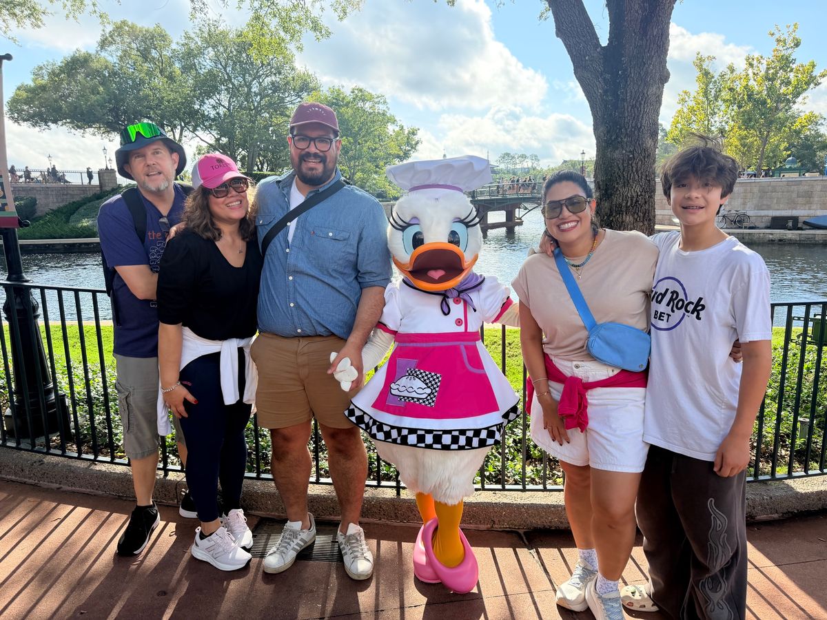 John Brandes and his family with Daisy Duck at Epcot's Food and Wine Festival